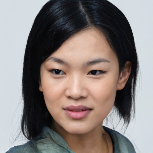Joyful asian young-adult female with medium  black hair and brown eyes