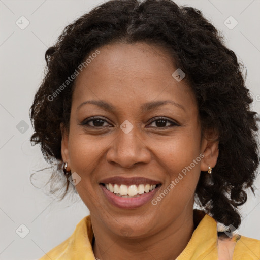 Joyful black adult female with medium  brown hair and brown eyes