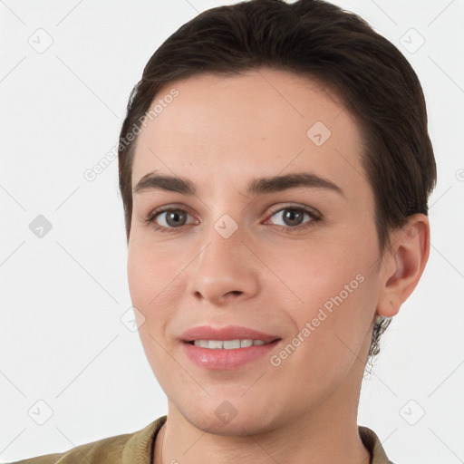 Joyful white young-adult female with short  brown hair and brown eyes