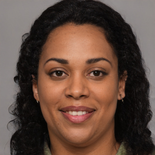 Joyful latino adult female with long  black hair and brown eyes