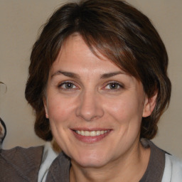 Joyful white adult female with medium  brown hair and brown eyes