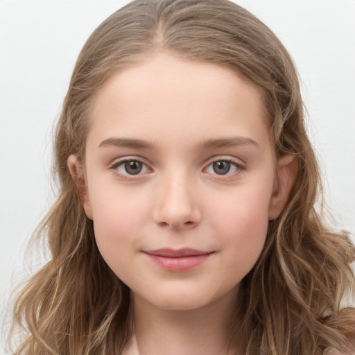 Joyful white child female with long  brown hair and brown eyes