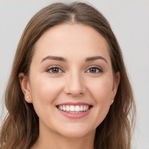 Joyful white young-adult female with long  brown hair and grey eyes