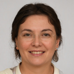 Joyful white adult female with medium  brown hair and brown eyes