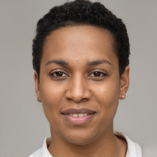 Joyful black young-adult female with short  black hair and brown eyes