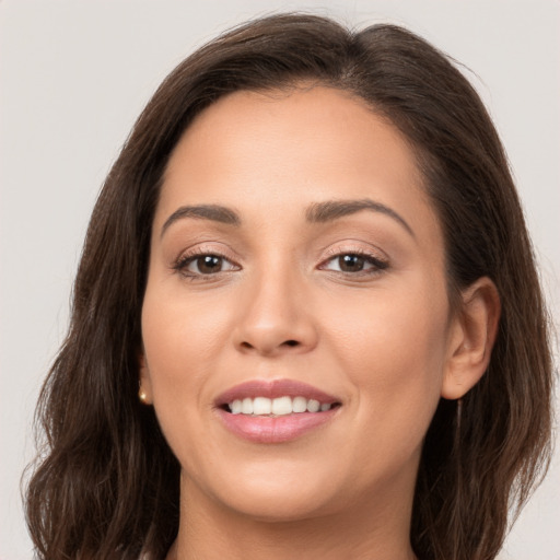 Joyful white young-adult female with long  brown hair and brown eyes