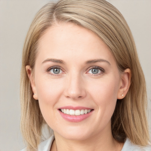 Joyful white young-adult female with medium  brown hair and blue eyes