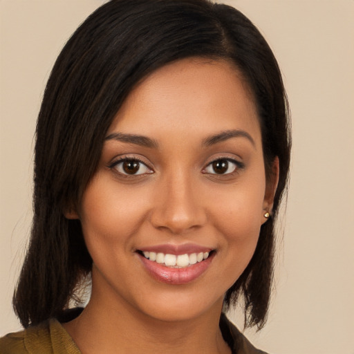 Joyful latino young-adult female with long  black hair and brown eyes