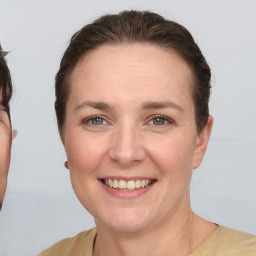 Joyful white young-adult female with short  brown hair and grey eyes