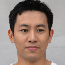 Joyful asian young-adult male with short  brown hair and brown eyes