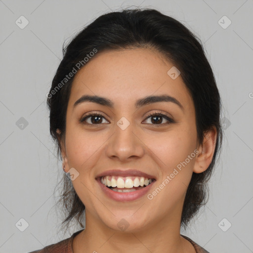 Joyful latino young-adult female with medium  brown hair and brown eyes