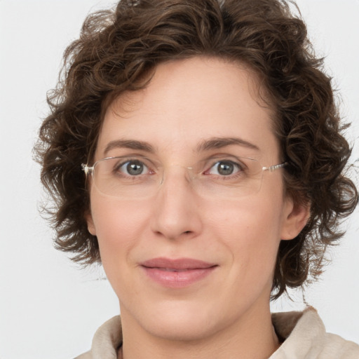 Joyful white young-adult female with medium  brown hair and green eyes