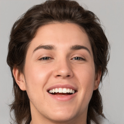 Joyful white young-adult male with medium  brown hair and brown eyes