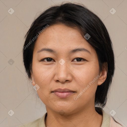 Joyful asian adult female with medium  brown hair and brown eyes