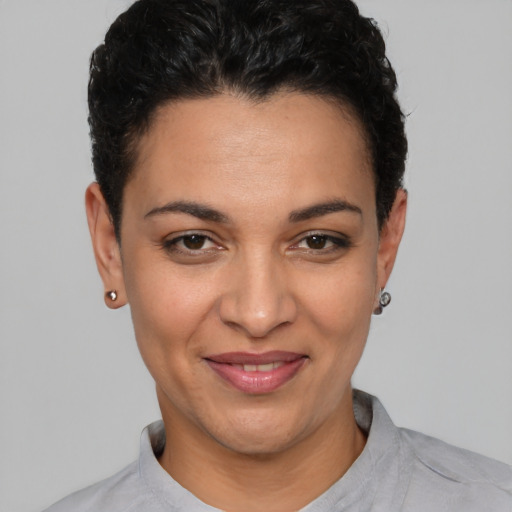 Joyful latino young-adult female with short  brown hair and brown eyes