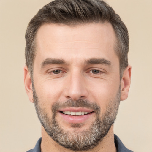 Joyful white adult male with short  brown hair and brown eyes