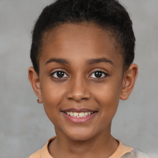 Joyful black child female with short  brown hair and brown eyes