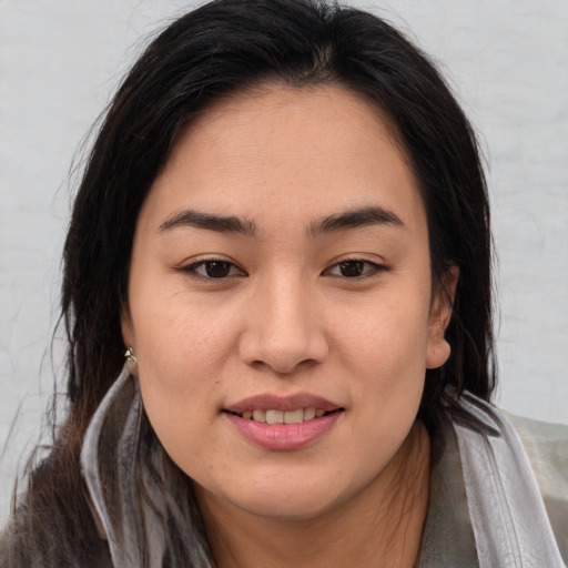 Joyful asian young-adult female with long  brown hair and brown eyes