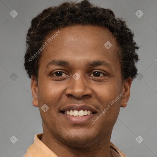 Joyful black young-adult male with short  brown hair and brown eyes