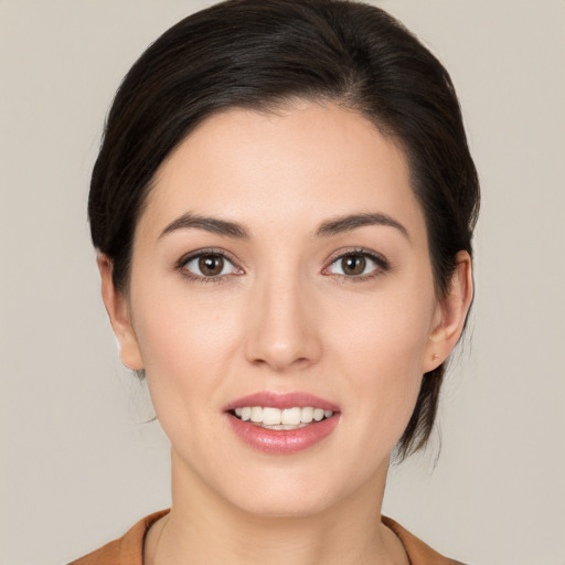 Joyful white young-adult female with medium  brown hair and brown eyes