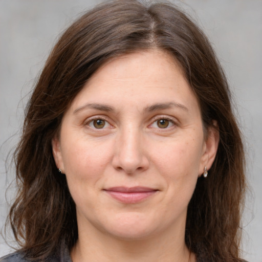 Joyful white adult female with medium  brown hair and brown eyes