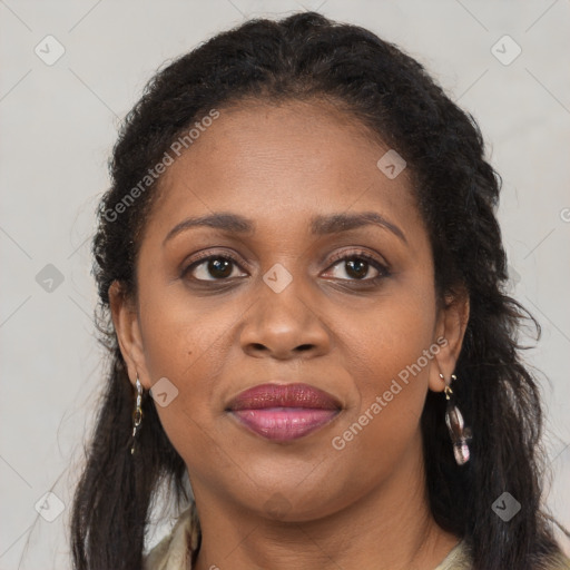 Joyful black adult female with long  brown hair and brown eyes