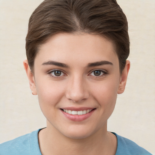 Joyful white young-adult female with short  brown hair and brown eyes