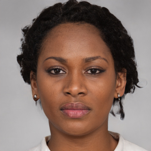 Neutral black adult female with medium  brown hair and brown eyes