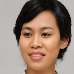 Joyful asian young-adult female with medium  black hair and brown eyes