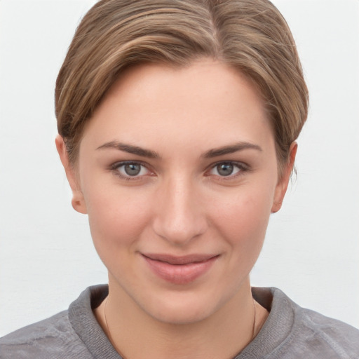 Joyful white young-adult female with short  brown hair and grey eyes