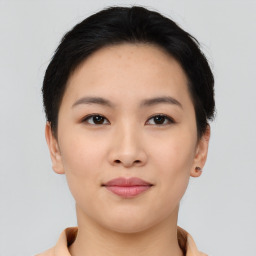 Joyful asian young-adult female with short  brown hair and brown eyes