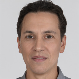 Joyful white adult male with short  brown hair and brown eyes