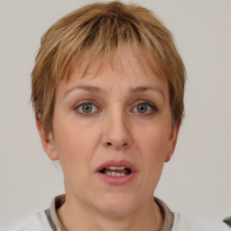 Joyful white adult female with short  brown hair and brown eyes