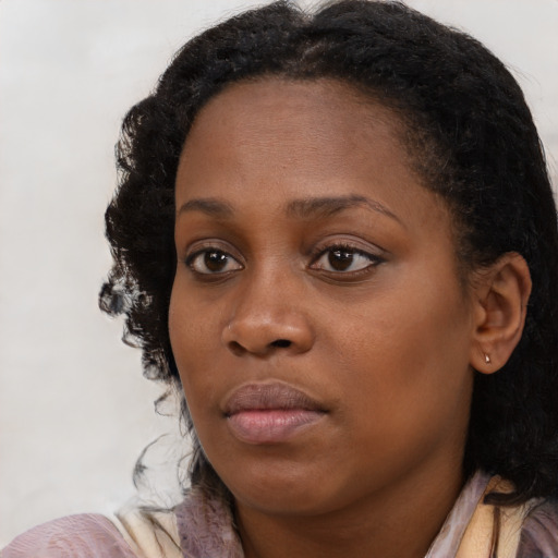 Neutral black young-adult female with medium  brown hair and brown eyes