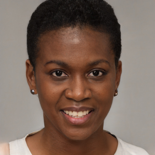Joyful black young-adult female with short  brown hair and brown eyes