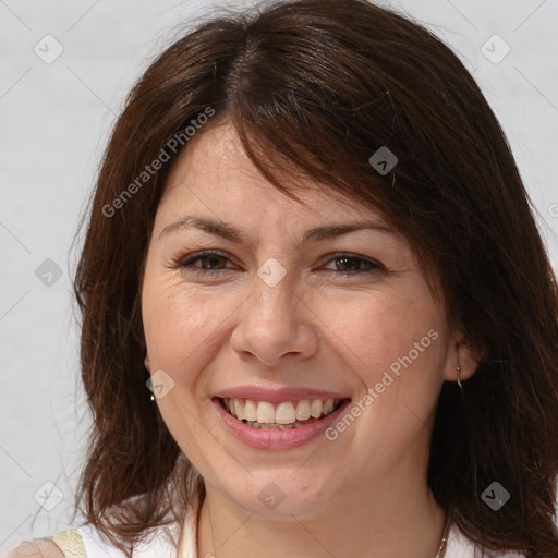 Joyful white adult female with medium  brown hair and brown eyes