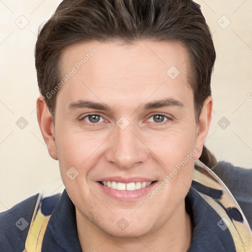 Joyful white young-adult male with short  brown hair and grey eyes