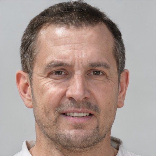 Joyful white middle-aged male with short  brown hair and brown eyes