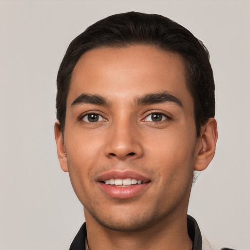 Joyful white young-adult male with short  black hair and brown eyes