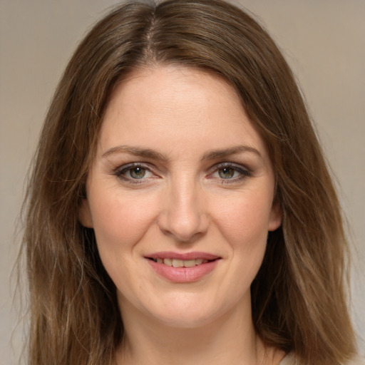 Joyful white young-adult female with long  brown hair and green eyes