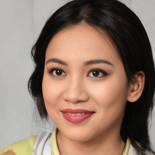 Joyful latino young-adult female with medium  black hair and brown eyes