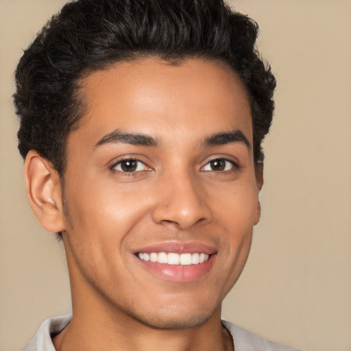 Joyful latino young-adult male with short  brown hair and brown eyes