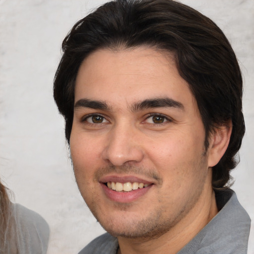 Joyful white young-adult male with medium  brown hair and brown eyes