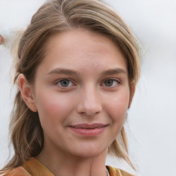 Joyful white young-adult female with long  brown hair and blue eyes