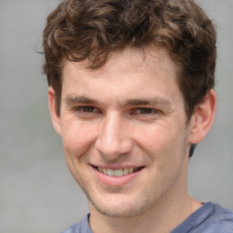 Joyful white adult male with short  brown hair and grey eyes