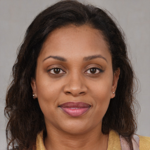 Joyful latino young-adult female with medium  brown hair and brown eyes