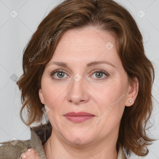 Joyful white young-adult female with medium  brown hair and blue eyes