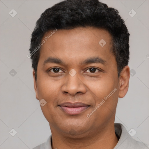 Joyful black young-adult male with short  black hair and brown eyes