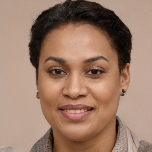 Joyful latino young-adult female with short  brown hair and brown eyes