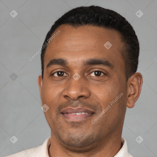 Joyful latino young-adult male with short  black hair and brown eyes